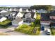 An aerial view of the home showcasing its green lawn, detached garage, screened-in patio, and backyard at 154 Helena Park Dr, Summerville, SC 29486