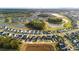 An aerial view of a well-designed community featuring houses near ponds, tree-lined streets, and verdant lawns at 154 Helena Park Dr, Summerville, SC 29486