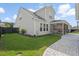 Well-maintained backyard with a stone paver pathway, green lawn, and a view of the screened-in patio at 154 Helena Park Dr, Summerville, SC 29486