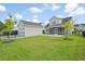 Large backyard with fenced yard, manicured green lawn, detached garage, and covered patio at 154 Helena Park Dr, Summerville, SC 29486
