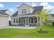 A spacious backyard featuring a covered patio and green lawn at 154 Helena Park Dr, Summerville, SC 29486