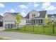 Spacious fenced backyard with manicured green lawn, detached garage, and covered patio at 154 Helena Park Dr, Summerville, SC 29486