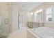 Bright bathroom features a double vanity, soaking tub, and tiled walk-in shower at 154 Helena Park Dr, Summerville, SC 29486