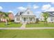 Charming single-story home featuring a manicured lawn, light beige siding, and a bright turquoise front door at 154 Helena Park Dr, Summerville, SC 29486