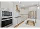 Modern kitchen features quartz countertops, herringbone backsplash, and stainless steel appliances at 154 Helena Park Dr, Summerville, SC 29486