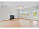 Bright living room features hardwood floors, a fireplace, and natural light from the windows at 154 Helena Park Dr, Summerville, SC 29486