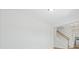 Bright living room with white walls, hardwood floors and staircase with modern finishes and natural light at 154 Helena Park Dr, Summerville, SC 29486