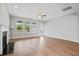 Open living space has hardwood floors, fireplace, ceiling fan, and windows overlooking a fenced-in backyard at 154 Helena Park Dr, Summerville, SC 29486