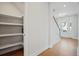 View of a pantry with shelving in an entryway with staircase and front door at 154 Helena Park Dr, Summerville, SC 29486