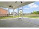 A screened-in patio with a view of the green lawn, houses across the street, and a blue sky dotted with clouds at 154 Helena Park Dr, Summerville, SC 29486