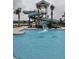 Community pool with a tall water slide, lifeguard chair, palm trees, and a view of homes on the water at 154 Helena Park Dr, Summerville, SC 29486