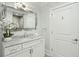 Elegant bathroom with marble countertop, framed mirror, and white cabinets at 155 Wingo Way # 433, Mount Pleasant, SC 29464