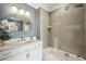 Bathroom featuring a modern vanity, stylish mirror, and tile-enclosed tub with shower at 155 Wingo Way # 433, Mount Pleasant, SC 29464