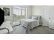 Modern bedroom with a gray bed, minimalist decor, and a large window at 155 Wingo Way # 433, Mount Pleasant, SC 29464