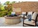 Inviting outdoor fire pit area with comfortable seating and a brick surround for cozy gatherings at 155 Wingo Way # 433, Mount Pleasant, SC 29464