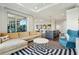 Open-concept living area with a modern kitchen, stylish furniture, and a large window bringing in natural light at 155 Wingo Way # 433, Mount Pleasant, SC 29464