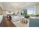 Bright living room featuring modern furniture, a stylish chandelier, and access to a private balcony with scenic views at 155 Wingo Way # 433, Mount Pleasant, SC 29464