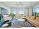 Bright living room with large windows offering scenic views, contemporary furniture, and bold striped rug at 155 Wingo Way # 433, Mount Pleasant, SC 29464