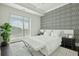 Serene main bedroom with large window, sleek black and white decor, bench, and patterned accent wall at 155 Wingo Way # 433, Mount Pleasant, SC 29464