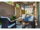 Charming patio area with comfortable seating, brick accents, and lush plants, creating a serene outdoor retreat at 155 Wingo Way # 433, Mount Pleasant, SC 29464