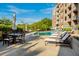 Resort-style pool area with lounge chairs, dining set, and lush greenery for outdoor relaxation and enjoyment at 155 Wingo Way # 433, Mount Pleasant, SC 29464