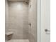 Modern tiled shower with built-in seat and brushed nickel shower head at 155 Wingo Way # 433, Mount Pleasant, SC 29464