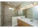 Bathroom featuring dual sinks, a shower with tile surround, and natural light at 1623 Adventure Xing # 109, Mount Pleasant, SC 29466
