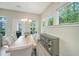 Bright dining room features natural lighting, stylish chandelier, and a glass cabinet for storage at 1623 Adventure Xing # 109, Mount Pleasant, SC 29466