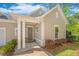 Inviting front entrance with brick walkway, covered porch, and beautifully landscaped garden at 1623 Adventure Xing # 109, Mount Pleasant, SC 29466