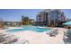 Inviting community pool with ample lounge seating and sun umbrellas, perfect for relaxation at 1623 Adventure Xing # 109, Mount Pleasant, SC 29466