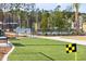 Well-maintained putting green with bench, and surrounding community elements at 1623 Adventure Xing # 109, Mount Pleasant, SC 29466
