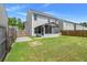 A backyard with a screened in porch, a wood fence, green grass, and a gray house at 169 Longford Dr, Summerville, SC 29483
