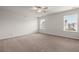 A spacious bedroom features neutral carpeting, white walls, with two windows for natural light at 169 Longford Dr, Summerville, SC 29483