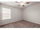 A simple bedroom featuring neutral carpeting, white walls, and a window for natural light at 169 Longford Dr, Summerville, SC 29483