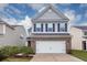 Two-story home featuring a brick and siding facade, attached garage, and manicured lawn at 169 Longford Dr, Summerville, SC 29483