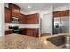 Kitchen with stainless steel appliances, granite countertops, tiled backsplash, and dark wood cabinetry at 169 Longford Dr, Summerville, SC 29483