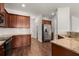 Bright kitchen features stainless steel refrigerator, and granite countertops with dark wood cabinetry at 169 Longford Dr, Summerville, SC 29483