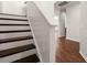 Staircase with carpet, and hardwood floors featuring neutral paint, and a view of the hallway at 169 Longford Dr, Summerville, SC 29483