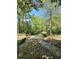 The property features a serene waterfront backyard and dock surrounded by lush trees at 1805 Wood Duck Rd, Moncks Corner, SC 29461