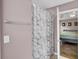 Bathroom with a marble-patterned shower curtain, with bedroom in view at 1954 Treebark Dr, Charleston, SC 29414