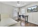 Bright bedroom with dark wood floors, work station, white walls, and TV at 1954 Treebark Dr, Charleston, SC 29414