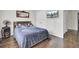 Bedroom with a grey comforter and dark wooden floors at 1954 Treebark Dr, Charleston, SC 29414