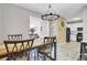 Inviting dining area featuring contemporary lighting, barstool seating, and access to the kitchen at 1954 Treebark Dr, Charleston, SC 29414