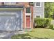 Close-up of a front door area featuring a brick entryway, siding, and well-manicured landscaping at 1954 Treebark Dr, Charleston, SC 29414