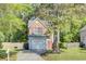 Two-story home with brick and vinyl siding featuring an attached garage and a well-maintained lawn at 1954 Treebark Dr, Charleston, SC 29414