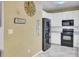 Well-lit kitchen featuring all white cabinets, tiled floors, and black appliances at 1954 Treebark Dr, Charleston, SC 29414