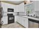 Bright kitchen with white cabinets, countertops, backsplash, and stainless steel dishwasher at 1954 Treebark Dr, Charleston, SC 29414