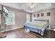 Bright main bedroom featuring hardwood floors, a ceiling fan, and natural light at 1954 Treebark Dr, Charleston, SC 29414