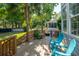 Inviting outdoor deck with plenty of seating surrounded by beautiful trees at 1977 Pierce St, Charleston, SC 29492
