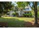 Spacious backyard with lush green grass, mature trees, and welcoming patio area at 1977 Pierce St, Charleston, SC 29492